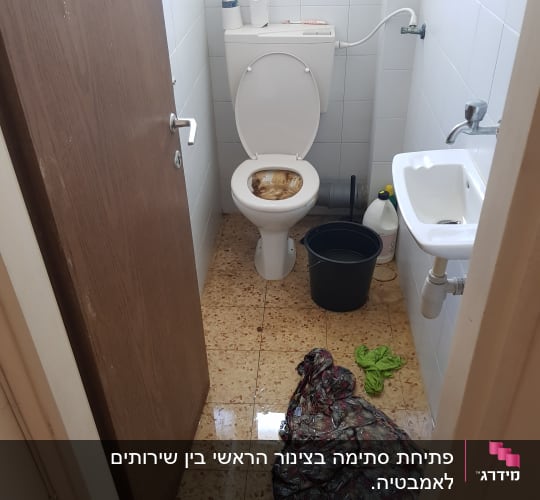 שירותים מוצפים עם דלי ומגב על הרצפה